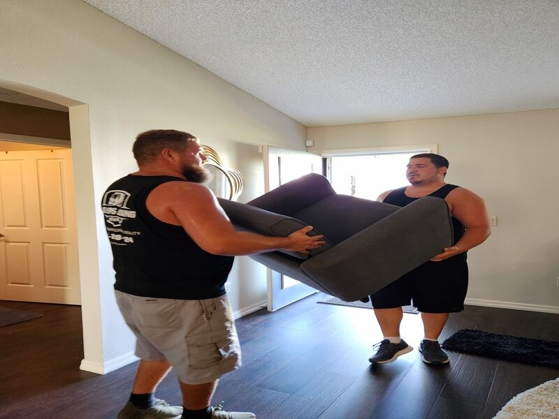 spring hill movers carrying couch inside home Hernando County FL